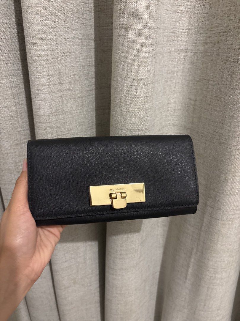 Michael Kors Black Leather Wallet with Gold Clasp (Category: Wallets & Card holders) located in Manila. Submitted by viee1777 (Listing ID 1461925993, Image 1). Description: - Authentic Michael Kors wallet - Color: Black leather - Closure: Gold turn-lock - Interior: Ample space for cards & cash, clean - Versatile: Ideal for everyday or night out - Condition: Great, clean interior .