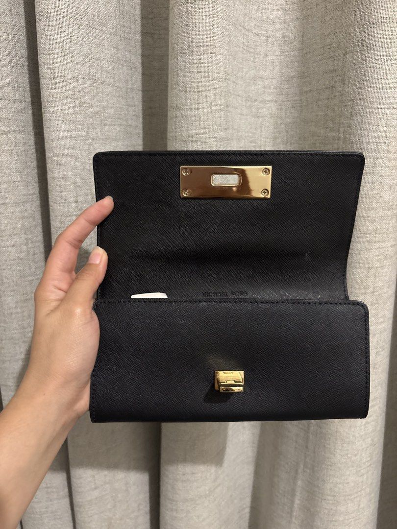 Michael Kors Black Leather Wallet with Gold Clasp (Category: Wallets & Card holders) located in Manila. Submitted by viee1777 (Listing ID 1461925993, Image 3). Description: - Authentic Michael Kors wallet - Color: Black leather - Closure: Gold turn-lock - Interior: Ample space for cards & cash, clean - Versatile: Ideal for everyday or night out - Condition: Great, clean interior .