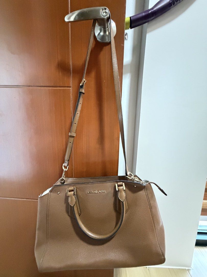 Michael Kors Brown Leather Satchel Handbag (Category: Luxury Bags & Wallets) located in Pasig City. Submitted by vastpenguin.796589 (Listing ID 1462031475, Image 1). Description: - Brand: Michael Kors with flaws inside - Original - Color: Brown - Material: Pebbled Leather - Features: Top handles, detachable crossbody strap - Hardware: Gold-tone - Interior: Spacious, great for essentials - Style: Everyday satchel bag.
