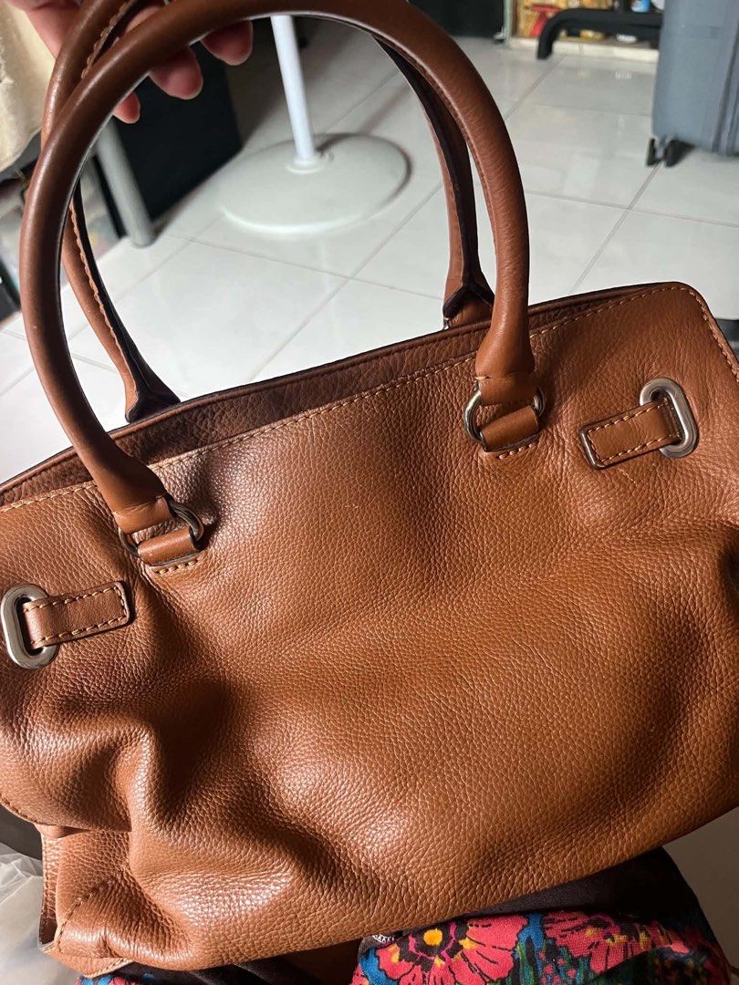 Michael Kors Leather Tote Bag (Category: Luxury Bags & Wallets) located in Tabaco. Submitted by devskie (Listing ID 1461799324, Image 3). Description: - 💯Authentic Michael Kors brown leather tote bag - Versatile with top handles and a detachable shoulder strap - Organized interior with a zippered compartment and pockets - Made in Vietnam - Ideal size for everyday essentials - No issues or flaws Price: 1600 FREE SHIPPING.