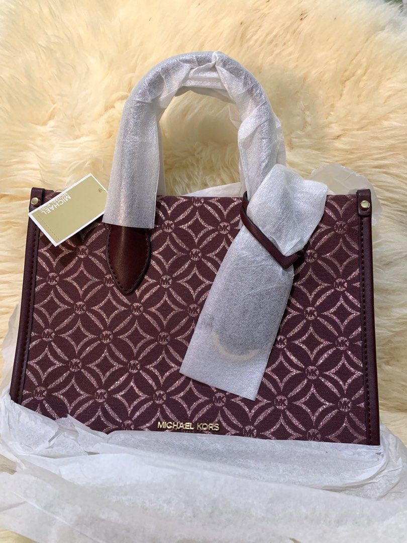 Michael Kors Monogram Burgundy Handbag (Category: Luxury Bags & Wallets) located in Manila. Submitted by mylildarlingamari (Listing ID 1461897656, Image 1). Description: - Authentic Michael Kors handbag - Deep burgundy color - Signature MK monogram pattern all over - Gold hardware details - Zipper closure - Comes with original tags - Protective wrapping intact (handle still plastic-wrapped).