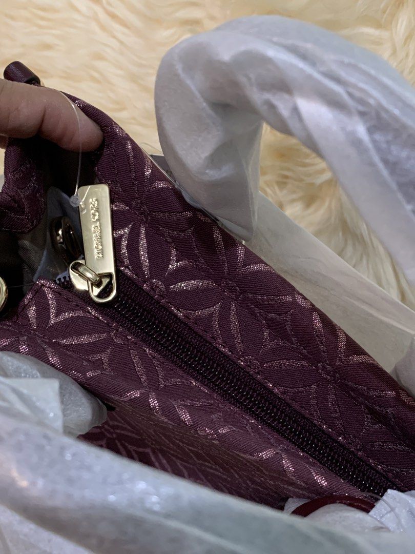 Michael Kors Monogram Burgundy Handbag (Category: Luxury Bags & Wallets) located in Manila. Submitted by mylildarlingamari (Listing ID 1461897656, Image 2). Description: - Authentic Michael Kors handbag - Deep burgundy color - Signature MK monogram pattern all over - Gold hardware details - Zipper closure - Comes with original tags - Protective wrapping intact (handle still plastic-wrapped).