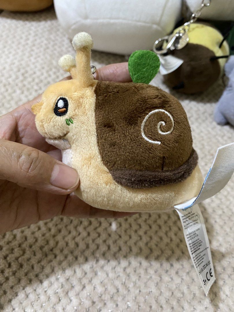 Micro Squishable Garden Snail Keychain (Category: Plushies & Soft Toys) located in Cavite. Submitted by momrocks (Listing ID 1461850713, Image 2). Description: Micro Squishable Garden Snail Keychain, featuring a soft brown shell and a cute little green sprout on top..