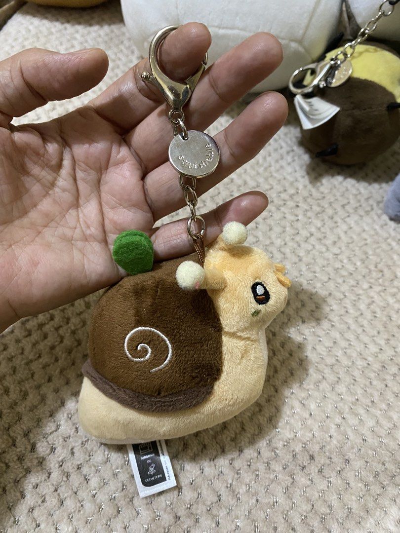 Micro Squishable Garden Snail Keychain (Category: Plushies & Soft Toys) located in Cavite. Submitted by momrocks (Listing ID 1461850713, Image 1). Description: Micro Squishable Garden Snail Keychain, featuring a soft brown shell and a cute little green sprout on top..