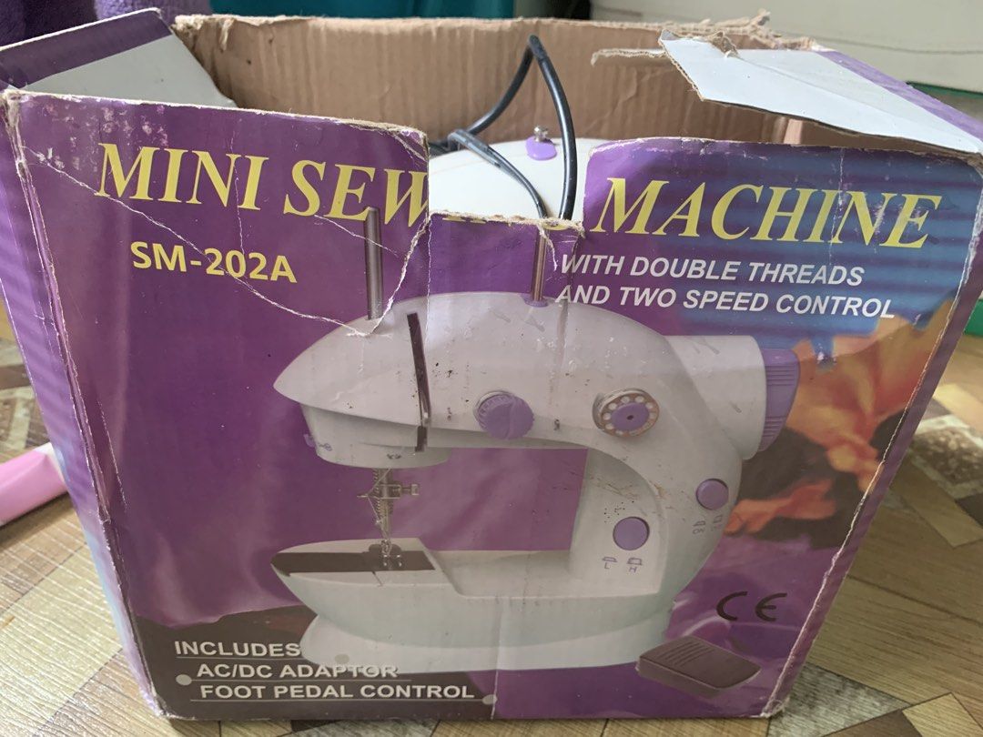 Mini Sewing Machine SM-202A with Double Threads (Category: Craft Supplies & Tools) located in Caloocan City. Submitted by diannecarl32964 (Listing ID 1461831569, Image 1). Description: - Mini Sewing Machine Model: SM-202A - Features: Double threads, 2 speed control - Includes: AC/DC adapter and foot pedal - Ideal for: Small sewing projects.