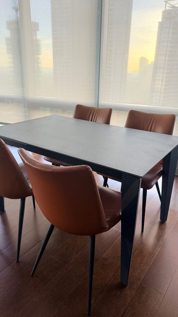 Modern Expandable Dining Table with 4 Chairs (Category: Tables & Sets) located in Manila. Submitted by happybangtan (Listing ID 1461892228, Image 3). Description: Rectangular dark grey dining table (tempered glass material with stone-like finish), 4 to 6 seater, can expand to 8 seater Dimensions: L 130cm to 180cm x W 80cm x H 75cm - Includes 4 brown faux leather chairs - Chairs feature stylish black metal legs - Ideal for small to medium dining a