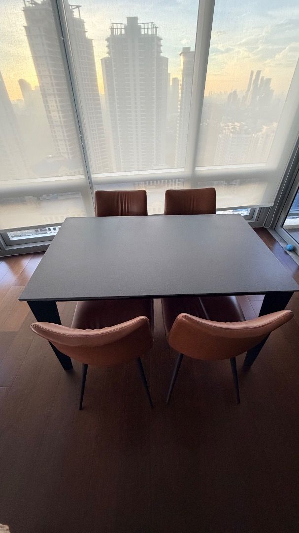 Modern Expandable Dining Table with 4 Chairs (Category: Tables & Sets) located in Manila. Submitted by happybangtan (Listing ID 1461892228, Image 2). Description: Rectangular dark grey dining table (tempered glass material with stone-like finish), 4 to 6 seater, can expand to 8 seater Dimensions: L 130cm to 180cm x W 80cm x H 75cm - Includes 4 brown faux leather chairs - Chairs feature stylish black metal legs - Ideal for small to medium dining a