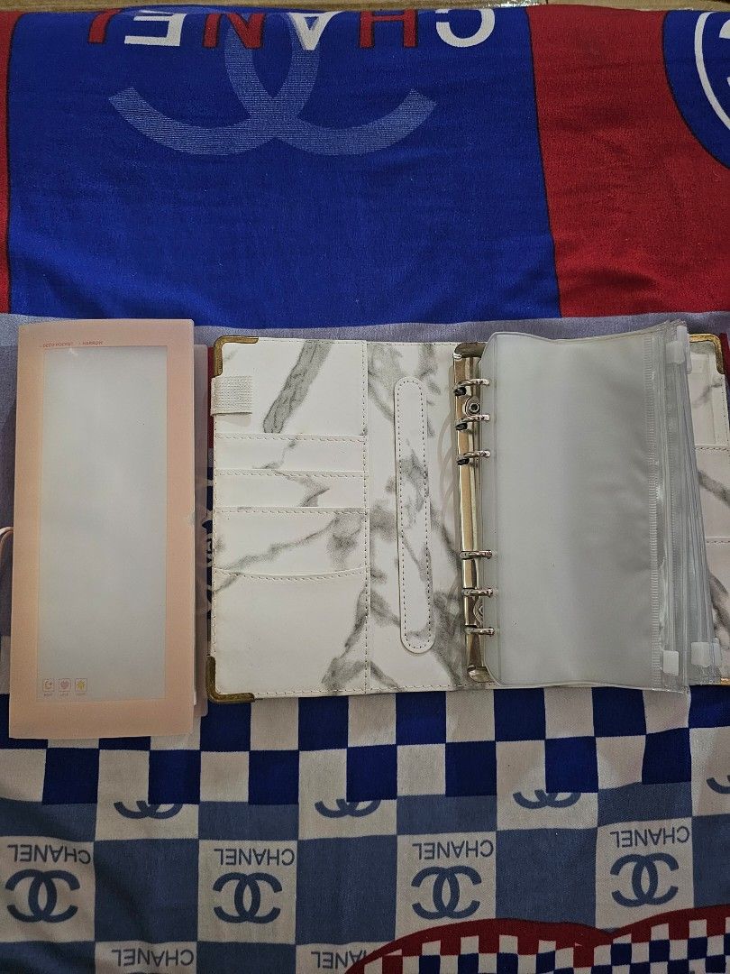 Money Binder (Category: Other Stationery & Craft) located in Lubao. Submitted by wakinaa (Listing ID 1461844972, Image 1). Description: left clear plastic divider page and a white marble-patterned binder used for cash budgeting or card storage white marble-patterned A6 PU leather budget binder and money organizer with 6 ring rings and clear zipper envelopes.