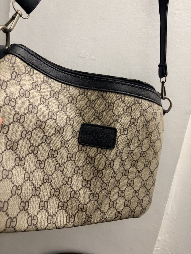 Monogram Crossbody Bag (Category: Luxury Bags & Wallets) located in Manila. Submitted by finderskeepersmnl_092026 (Listing ID 1461958103, Image 1). Description: - Classic Gucci crossbody bag - Iconic GG monogram pattern - Black leather trim and strap - Zipper closure - Perfect for everyday use.