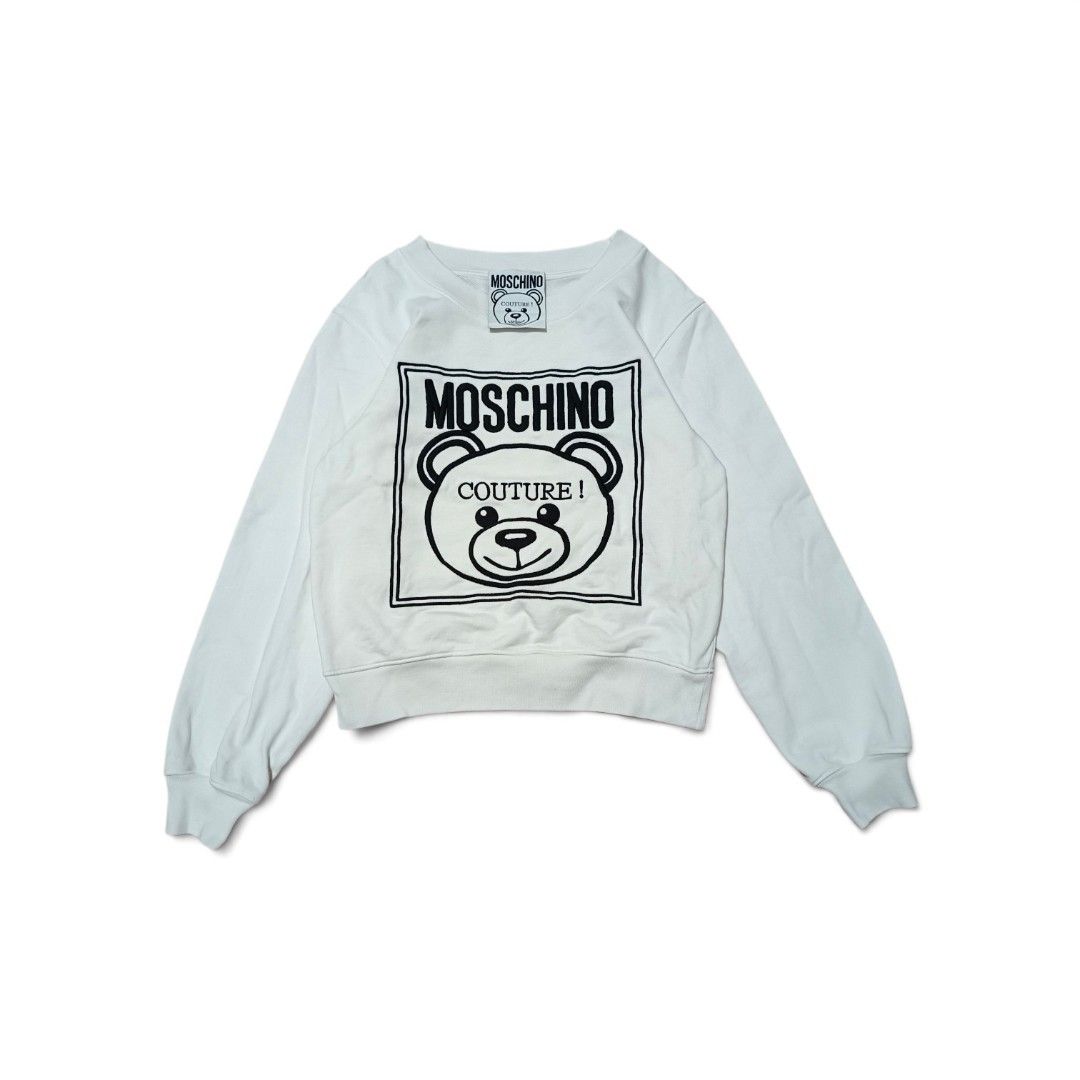 Moschino Couture Teddy Bear Sweatshirt (Category: Coats, Jackets and Outerwear) located in Manila. Submitted by southstreethub.ph (Listing ID 1461873242, Image 1). Description: - Authentic White Moschino Couture Sweatshirt - Condition: Like new Condition - Dimention: 18 Width 21 Lenght - Features iconic Moschino teddy bear graphic - 'Moschino Couture!' text detail - Made in Portugal - Ideal for stylish casual wear.