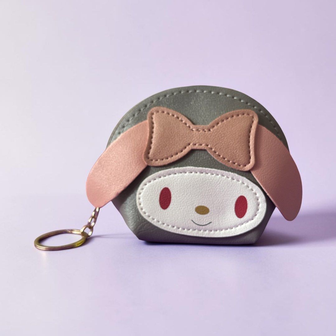 My Melody Coin Purse Mini (Category: Purses & Pouches) located in Quezon City. Submitted by ghessie (Listing ID 1461866993, Image 3). Description: ₱100 each - Adorable My Melody coin purse featuring her iconic face, pink bow, and long ears. - Includes a convenient keychain ring for easy attachment. - Perfect for storing coins, keys, or other small essentials. - Available in a variety of colors: pink, light pink, black, grey, teal, and blue..