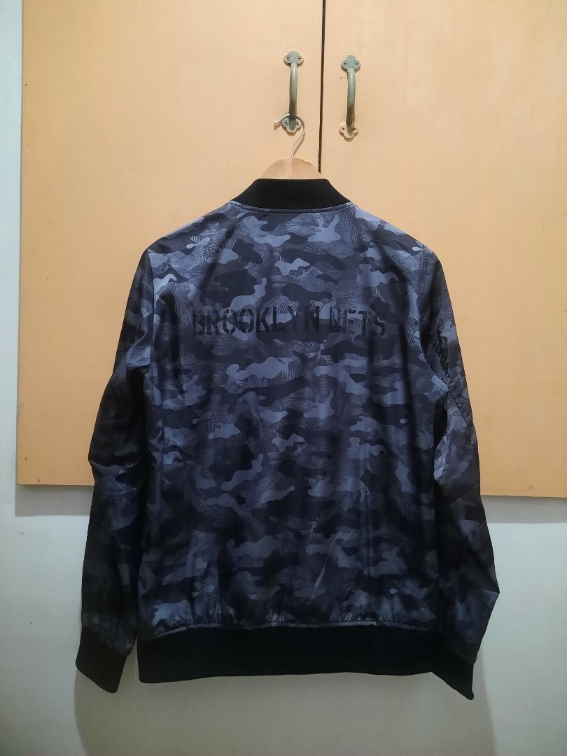 AUTHENTIC NBA 'BROOKLYN NETS BLACK CAMO' BOMBER JACKET (Category: Coats, Jackets and Outerwear) located in Manila. Submitted by ako.si.lemmor (Listing ID 1461849861, Image 2). Description: This item is authentic but thrifted, manage your expectation. Dimes: 19.5X26.5 (M-L) Color rate: 9/10 Issue: Print fade, see pictures Ship at your own cost or pickup Mandaluyong..