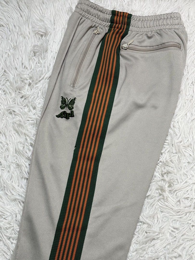 Needles japan (Category: Trousers) located in Baguio. Submitted by sellingtonshop (Listing ID 1461844640, Image 2). Description: r43. Needles x AIPL track pants Size: S-M W: 28-30 L: 37 Inseam: 26 Leg opening: 7.5 Condition: very good Issue: small stains and loose stitch Mine: 980 Steal: 1080 Grab: 1280.