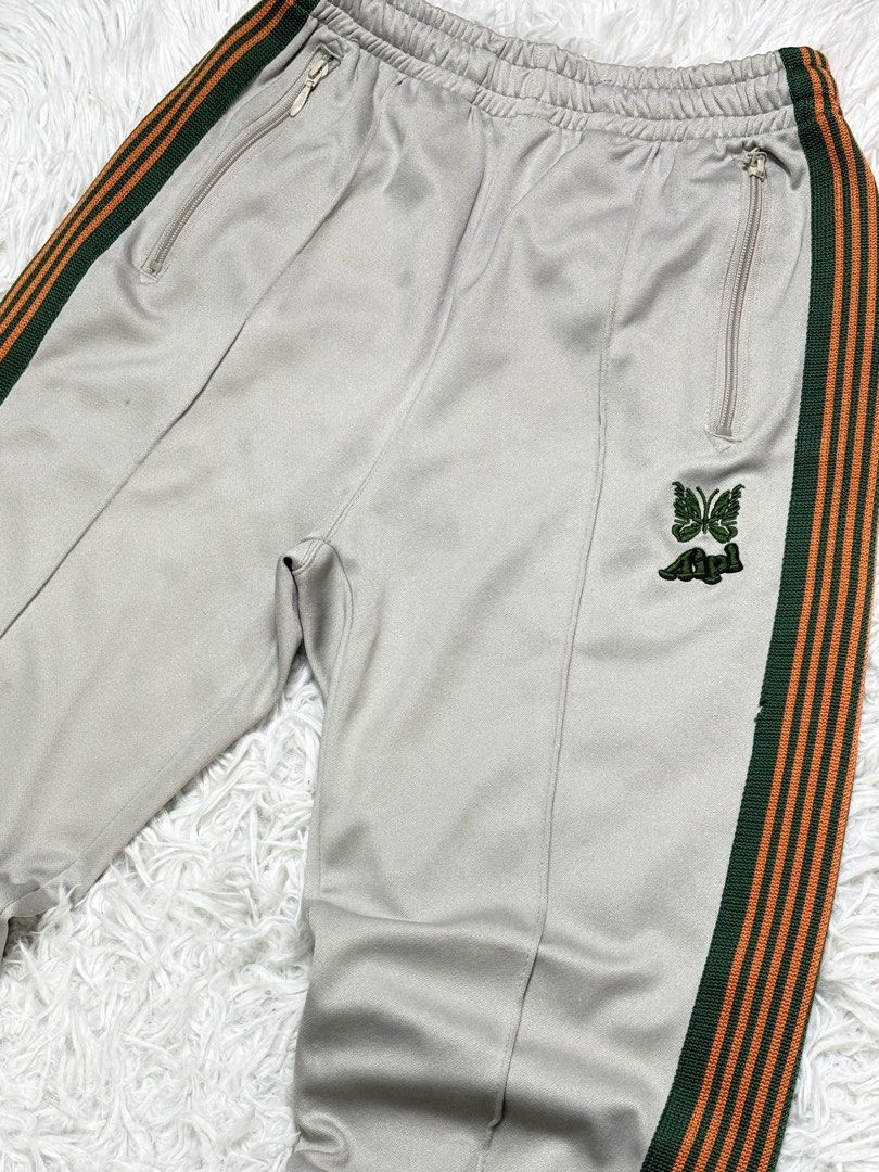 Needles japan (Category: Trousers) located in Baguio. Submitted by sellingtonshop (Listing ID 1461844640, Image 3). Description: r43. Needles x AIPL track pants Size: S-M W: 28-30 L: 37 Inseam: 26 Leg opening: 7.5 Condition: very good Issue: small stains and loose stitch Mine: 980 Steal: 1080 Grab: 1280.
