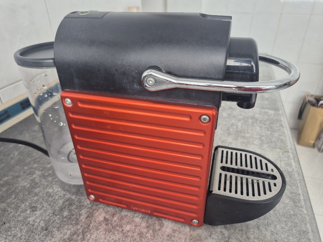 Nespresso Pixie (Red) (Category: Coffee Machines & Makers) located in Singapore. Submitted by purplenuts (Listing ID 1461864775, Image 2). Description: Selling my Nespresso Pixie Original Line capsule coffee machine in Electric Red. - Heats up in just 25 seconds - One-touch Espresso & Lungo buttons - Stylish polished metal side panels - Solid steel handle — sturdy and premium feel - Compact design, perfect for home or office - Thoroughly cleaned 