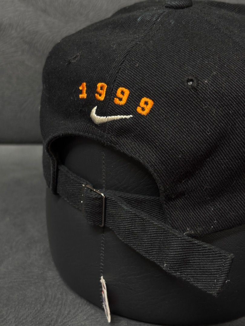 Nike 1999 Embroidered Baseball Cap (Category: Caps & Hats) located in Antipas. Submitted by charsonaesthetics (Listing ID 1461969503, Image 3). Description: - Black Nike baseball cap - Embroidered circular logo on front with '333' and 'N' - '1999' and Nike swoosh embroidered on the back - Adjustable strap for a comfortable fit - Ideal for casual outfits.