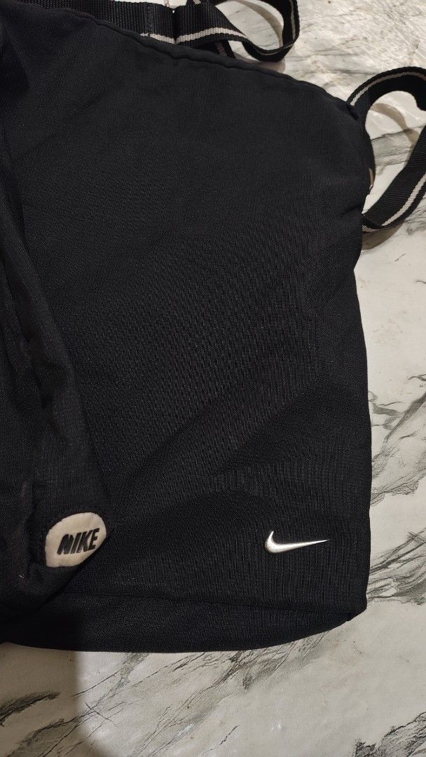 Nike Black Crossbody Bag (Category: Cross-body Bags) located in Inabanga. Submitted by once.twice (Listing ID 1461847611, Image 3). Description: - Black Nike crossbody bag - Features iconic Nike swoosh logo - Adjustable strap for comfortable wear - Light-colored interior for easy visibility - Secure zipper closure - Ideal for everyday use.