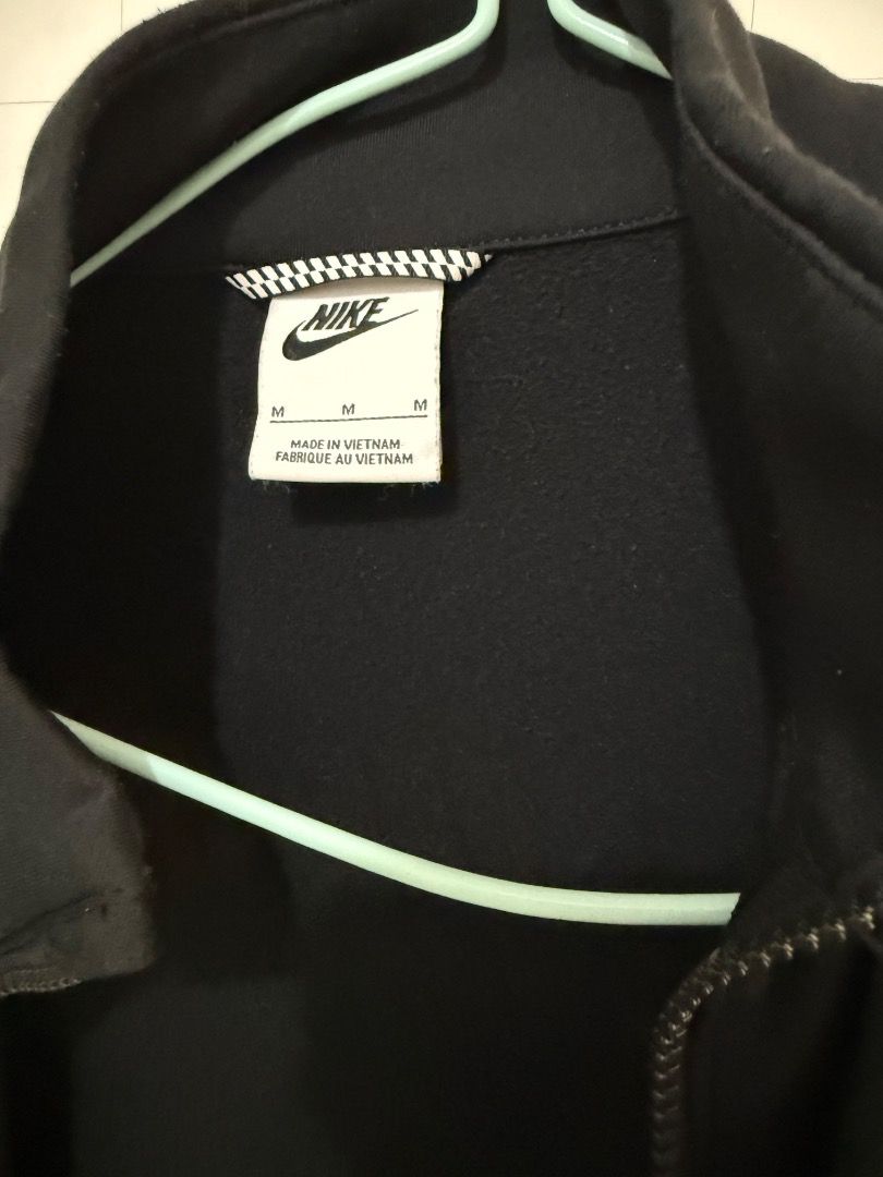 Nike Black Full Zip Track Jacket (Category: Babies & Kids Fashion) located in Valenzuela. Submitted by edellemei102082 (Listing ID 1461843567, Image 2). Description: - Classic black Nike track jacket - Full zip closure - Iconic Nike logo on chest - Larger Nike logo on back - Made in Vietnam - Size: Medium (M) - Ideal for casual wear or workouts.