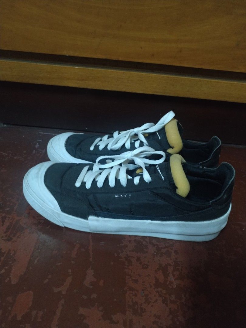 Nike Drop Type LX (Category: Sneakers) located in Manila. Submitted by patrickdeclutters (Listing ID 1461890785, Image 1). Description: Black Nike SB Zoom Blazer Low sneakers with white laces and soles. Features "N.357" detail and yellow ankle padding. Minor scuffs on soles. Perfect for skating or casual wear..