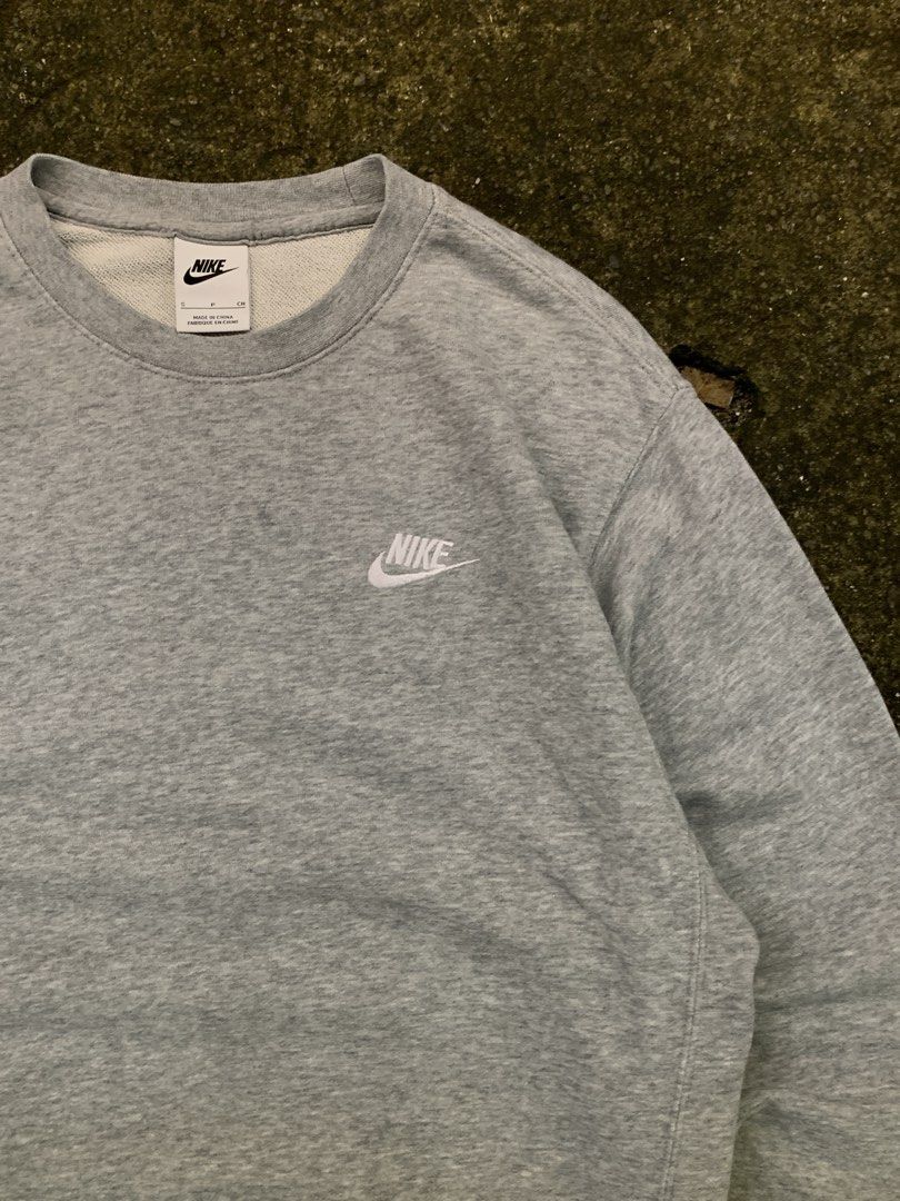 Nike Grey Crewneck Sweatshirt (Category: Coats, Jackets and Outerwear) located in Manila. Submitted by loyspalencia (Listing ID 1461850538, Image 2). Description: - Classic grey Nike crewneck sweatshirt - Features iconic embroidered Nike logo on the chest - Made from a comfortable fabric blend - Versatile for everyday wear or layering - Easy to pair with any outfit - Dimes: W-20 / L-25/ Sleeve-22.