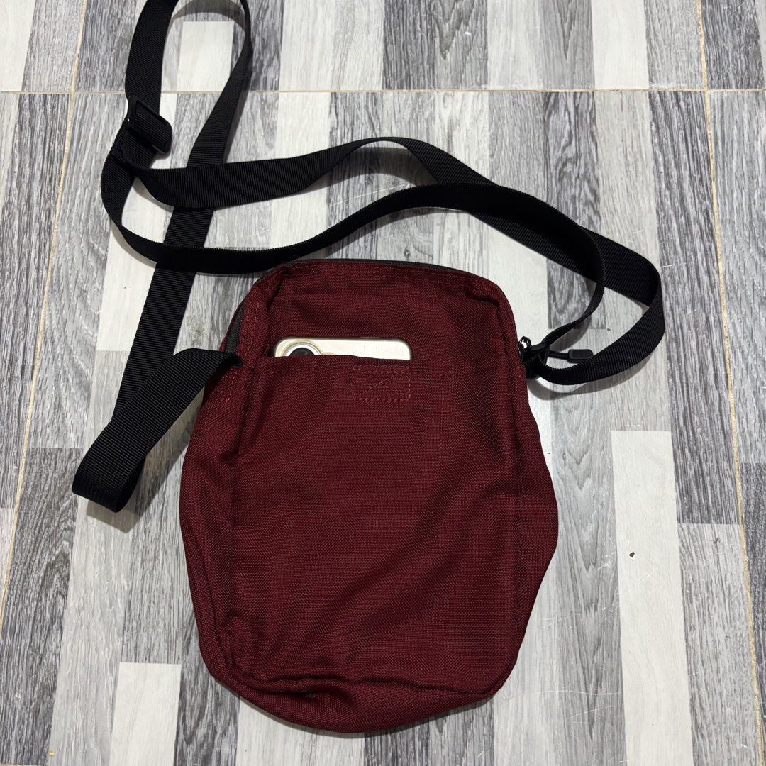 Nike Maroon Crossbody Bag (Category: Cross-body Bags) located in Banga. Submitted by akosiloco (Listing ID 1461920263, Image 2). Description: - Stylish maroon Nike crossbody bag - Convenient front zip pocket - Spacious main compartment - Handy back slip pocket (fits your phone!) - Adjustable strap for a comfortable fit - Durable 100% polyester material - Ideal for everyday errands or your next adventure!.