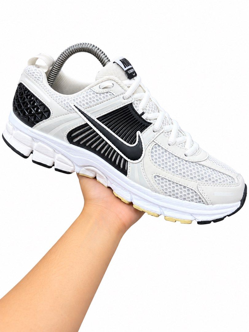 Nike Vomero 5 Sneakers White Black (Category: Sneakers) located in Valenzuela. Submitted by boutiquechic (Listing ID 1461921808, Image 2). Description: - Nike Vomero 5 running shoes - Color: White with black accents - Features: Breathable mesh upper, cushioned sole for comfort - Versatile: Great for running or everyday wear - Condition: Shows some signs of wear on the soles.