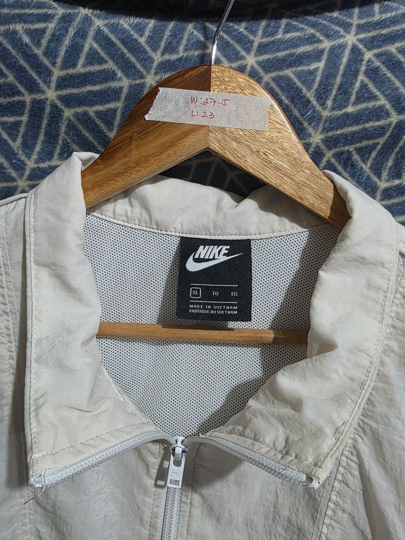 Nike White & Red Windbreaker Jacket (Category: Coats, Jackets and Outerwear) located in Quezon City. Submitted by kick_mnl (Listing ID 1461866736, Image 3). Description: - White Nike windbreaker jacket - Red accent details - Quarter zip closure - Small Nike logo on chest - Drawstring at hem for adjustable fit - Ideal for layering or light weather protection.
