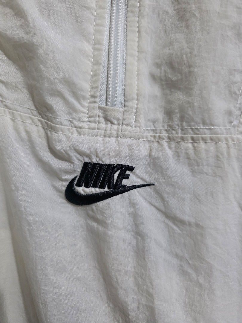 Nike White & Red Windbreaker Jacket (Category: Coats, Jackets and Outerwear) located in Quezon City. Submitted by kick_mnl (Listing ID 1461866736, Image 2). Description: - White Nike windbreaker jacket - Red accent details - Quarter zip closure - Small Nike logo on chest - Drawstring at hem for adjustable fit - Ideal for layering or light weather protection.