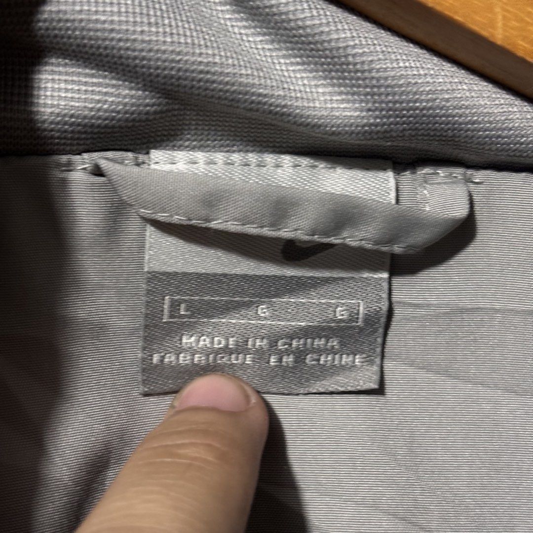 Nike Windbreaker Jacket - Grey/Black - Size L (Category: Coats, Jackets and Outerwear) located in Caloocan City. Submitted by bonsatocha43876 (Listing ID 1461981621, Image 2). Description: - Authentic Nike windbreaker jacket - Stylish two-tone grey and black design - Features the classic Nike swoosh logo - Side stripe detailing on sleeves - Full zip closure for easy wear - Tagged size Large (L) - Measurements: Width 22 inches, Length 28 inches - 
