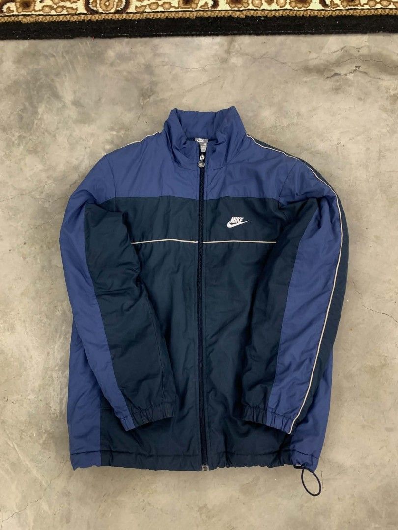 Nike Windbreaker Jacket Blue Dark Blue (Category: Coats, Jackets and Outerwear) located in Manila. Submitted by rodeltzy (Listing ID 1461983954, Image 1). Description: - Classic Nike windbreaker - Two-tone blue and dark blue colorway - White piping detail on chest and sleeves - Elasticated cuffs and hem with drawstring - Full zip closure - Ideal for everyday wear or light workouts.