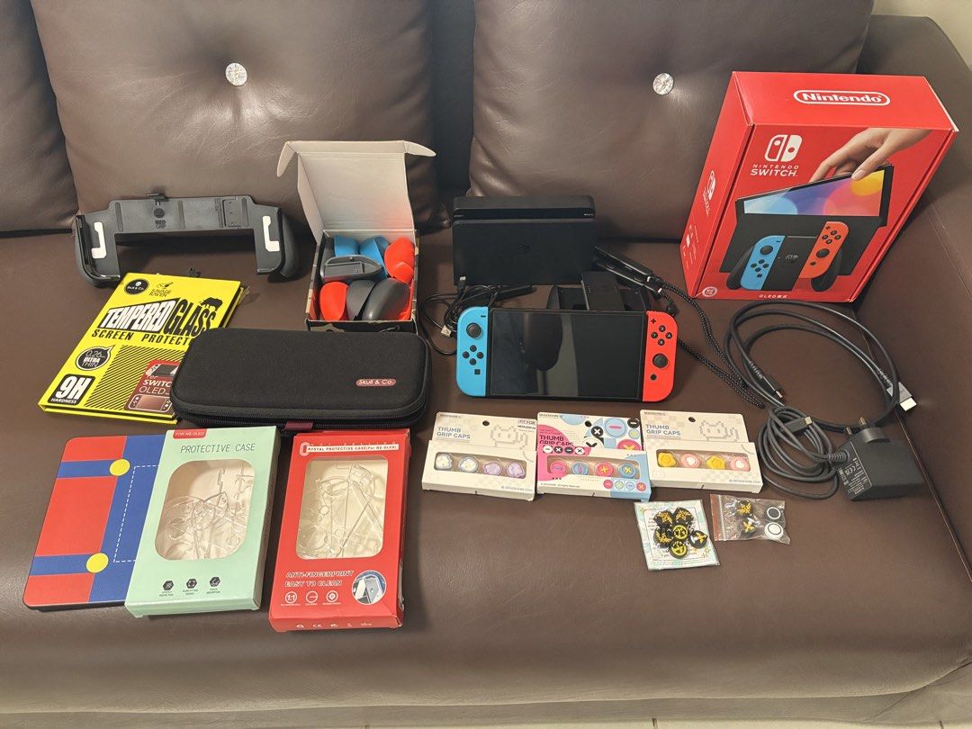 Nintendo Switch OLED w accessories (Category: Nintendo) located in Cavite. Submitted by mjalucero (Listing ID 1462018335, Image 1). Description: ‼️FOR SALE ONLY‼️ Nintendo Switch OLED Includes (all original): - Switch OLED - Joycons - Box - Charging Cable - HDMI - Joycon Grip - Dock - Joycon Straps Comes with the ff accessories: - Skull & Co. Slim Carrying Case - Skull & Co. Grip with Gray and Colored grips - 1x extra Screen protector (has one in