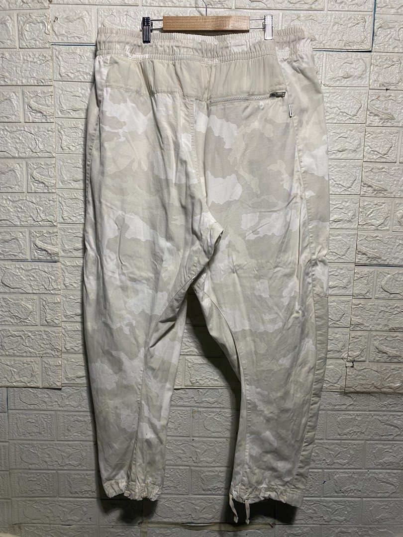 NSW Camo Cargo Pants (Category: Joggers) located in Naga. Submitted by thesource4400 (Listing ID 1461953534, Image 2). Description: - Lightweight NSW camouflage cargo pants - Elastic waistband with adjustable drawstring - Zip fly and button closure - Two side pockets - One back zip pocket - Adjustable drawstring at the ankles - Embroidered logo on the left leg - Ideal for casual everyday wear.