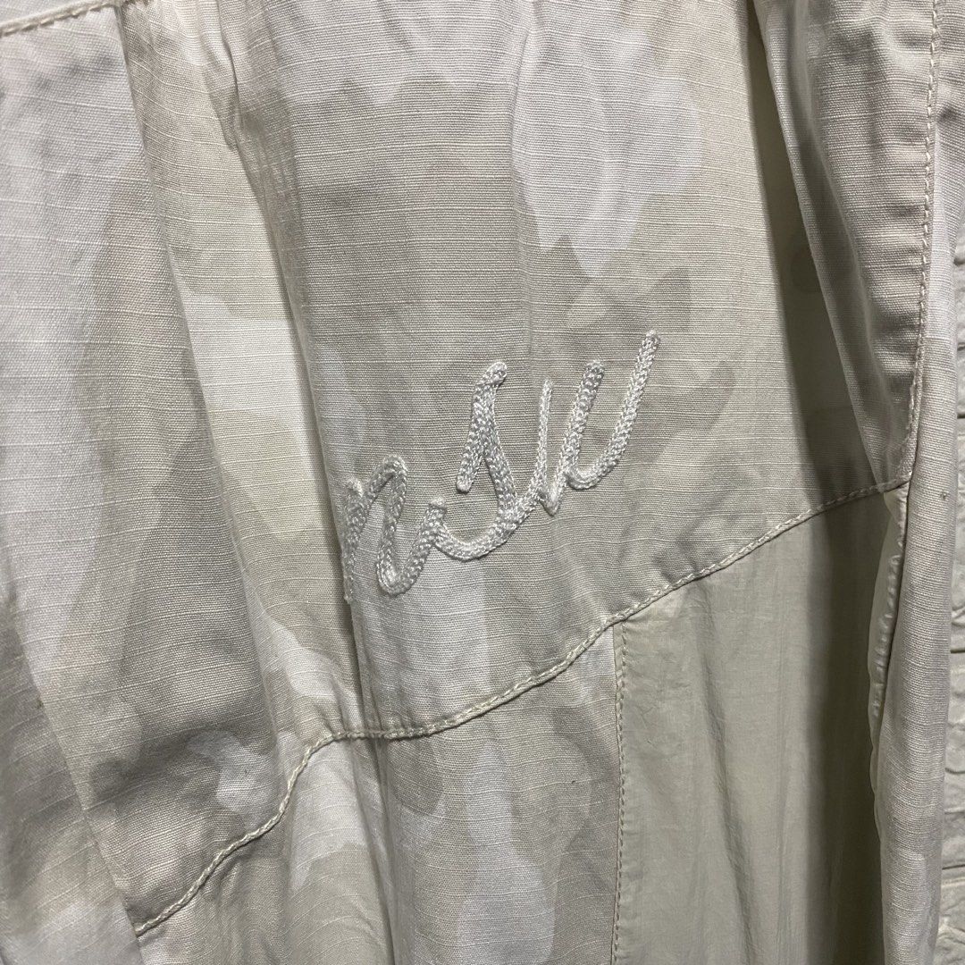 NSW Camo Cargo Pants (Category: Joggers) located in Naga. Submitted by thesource4400 (Listing ID 1461953534, Image 3). Description: - Lightweight NSW camouflage cargo pants - Elastic waistband with adjustable drawstring - Zip fly and button closure - Two side pockets - One back zip pocket - Adjustable drawstring at the ankles - Embroidered logo on the left leg - Ideal for casual everyday wear.