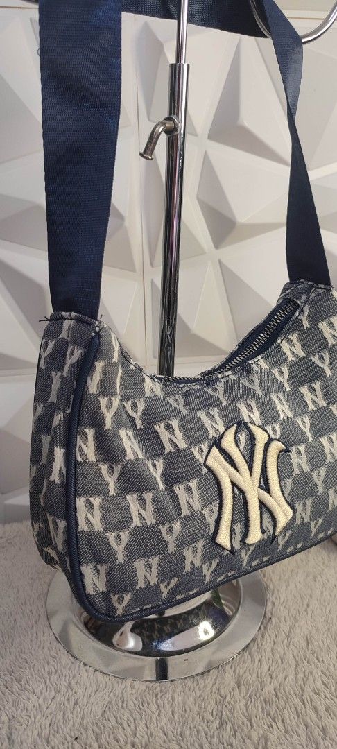 MLB Yankees Denim Shoulder Bag (Category: Shoulder Bags) located in Pasig City. Submitted by xcess_baggage (Listing ID 1461825010, Image 2). Description: - Stylish denim shoulder bag featuring an all-over NY Yankees logo print. - Prominent embroidered NY Yankees logo patch on the front. - Durable navy blue shoulder strap. - Secure zipper closure. - A must-have accessory for any New York Yankees fan..