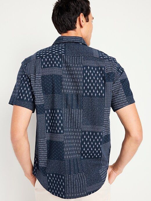 Old Navy Men's Patchwork Print Short Sleeve Button-Up Shirt (Category: Tshirts & Polo Shirts ) located in Plaridel. Submitted by ilovebubu28 (Listing ID 1461801788, Image 3). Description: - Old Navy short sleeve shirt - Cool patchwork print - Navy blue with subtle grey pattern - Button-up front - Features a chest pocket - Perfect for casual wear - Pairs well with shorts or jeans.