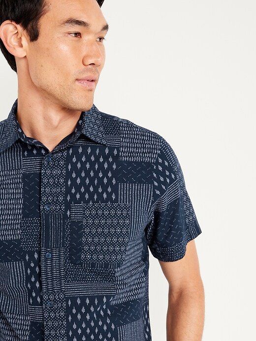 Old Navy Men's Patchwork Print Short Sleeve Button-Up Shirt (Category: Tshirts & Polo Shirts ) located in Plaridel. Submitted by ilovebubu28 (Listing ID 1461801788, Image 1). Description: - Old Navy short sleeve shirt - Cool patchwork print - Navy blue with subtle grey pattern - Button-up front - Features a chest pocket - Perfect for casual wear - Pairs well with shorts or jeans.