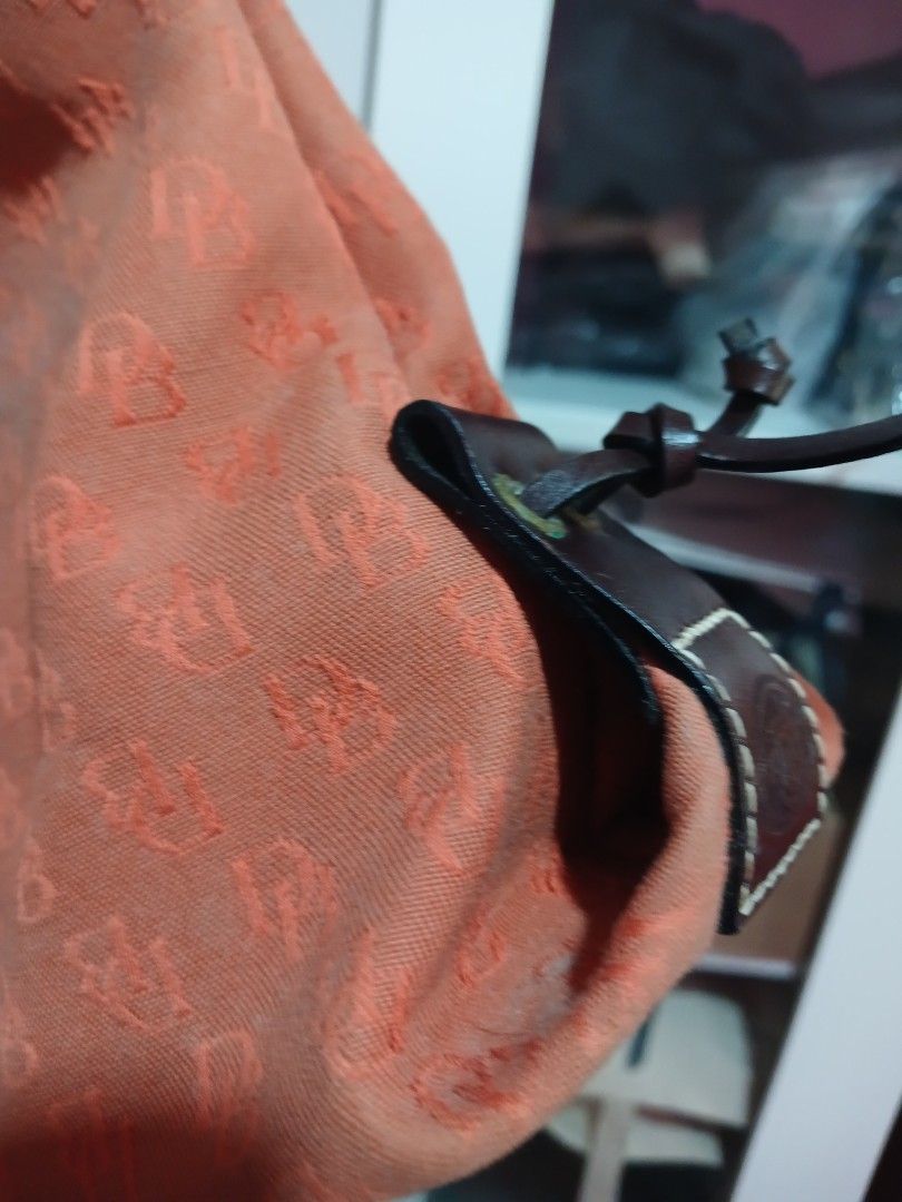 Orange Monogram Drawstring Bucket Bag with Leather Accents (Category: Luxury Bags & Wallets) located in Marikina City. Submitted by laila15 (Listing ID 1461955267, Image 2). Description: - Chic orange bucket bag with repeating monogram pattern - Features stylish leather drawstrings and comfortable handles - Multiple interior pockets for excellent organization - Secure magnetic snap closure - Ideal for everyday errands or your next getaway.