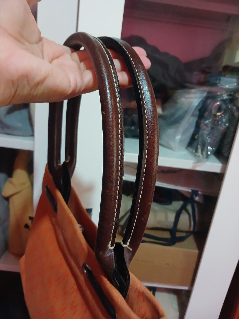 Orange Monogram Drawstring Bucket Bag with Leather Accents (Category: Luxury Bags & Wallets) located in Marikina City. Submitted by laila15 (Listing ID 1461955267, Image 3). Description: - Chic orange bucket bag with repeating monogram pattern - Features stylish leather drawstrings and comfortable handles - Multiple interior pockets for excellent organization - Secure magnetic snap closure - Ideal for everyday errands or your next getaway.