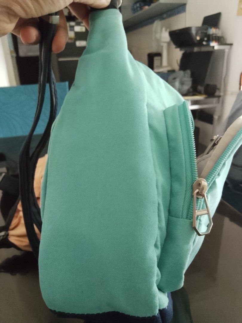 Pacsafe Teal Crossbody Bag (Category: Cross-body Bags) located in Antipolo. Submitted by jarreb (Listing ID 1461963584, Image 3). Description: - Teal Pacsafe crossbody bag - Multiple zippered compartments for organization - Spacious main compartment - Front pocket with internal zip pocket - Adjustable strap - Ideal for travel or everyday use - Clean interior.