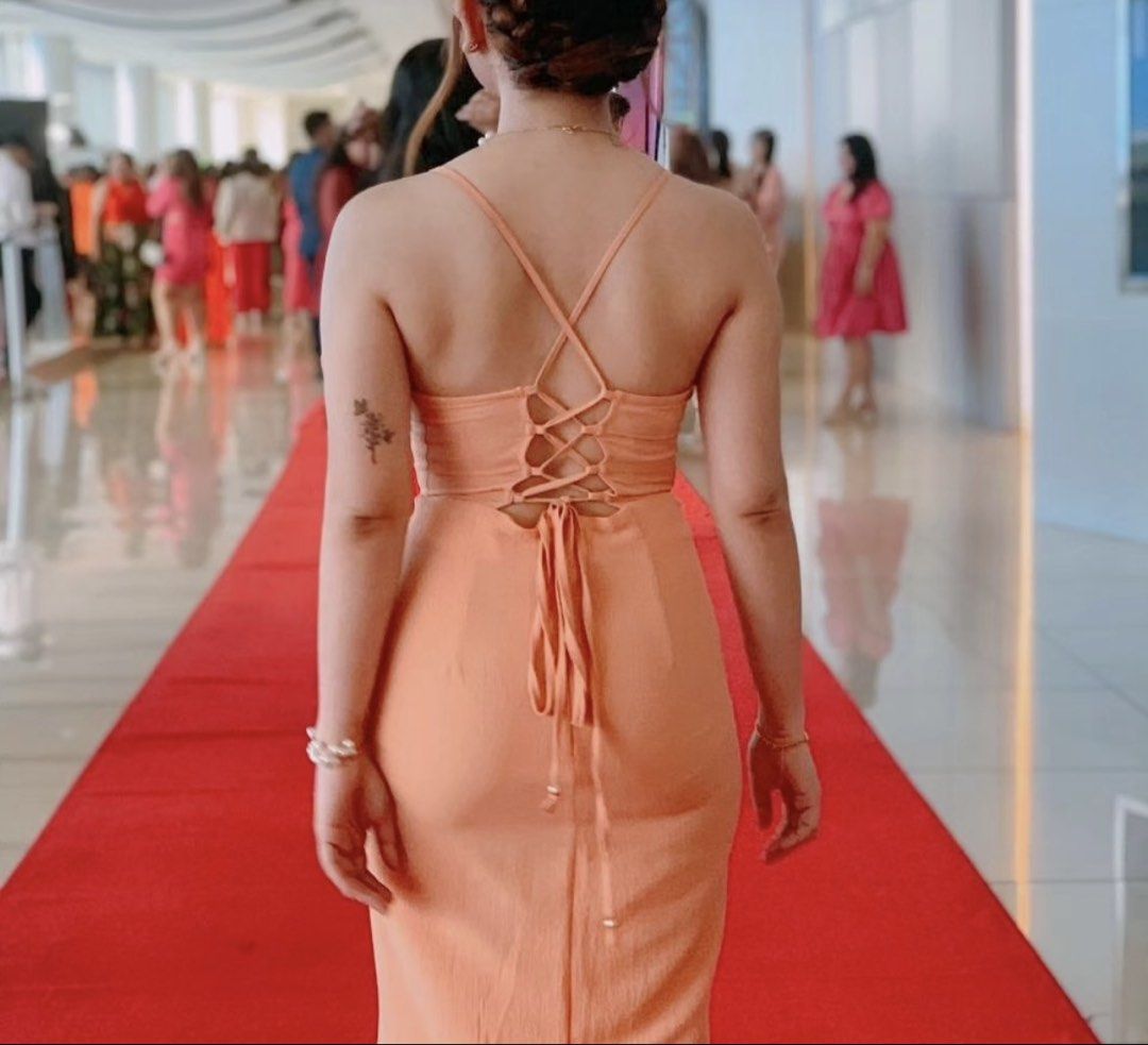 Peach Spaghetti Strap Lace-Up Back Maxi Dress (Category: Dresses) located in Manila. Submitted by _dar_ (Listing ID 1461986063, Image 3). Description: - Stunning peach maxi dress - Features spaghetti straps and a plunging neckline - Elegant lace-up back detail - Fitted silhouette for a flattering look - Comfortable and chic design - Ideal for special events or a night out.