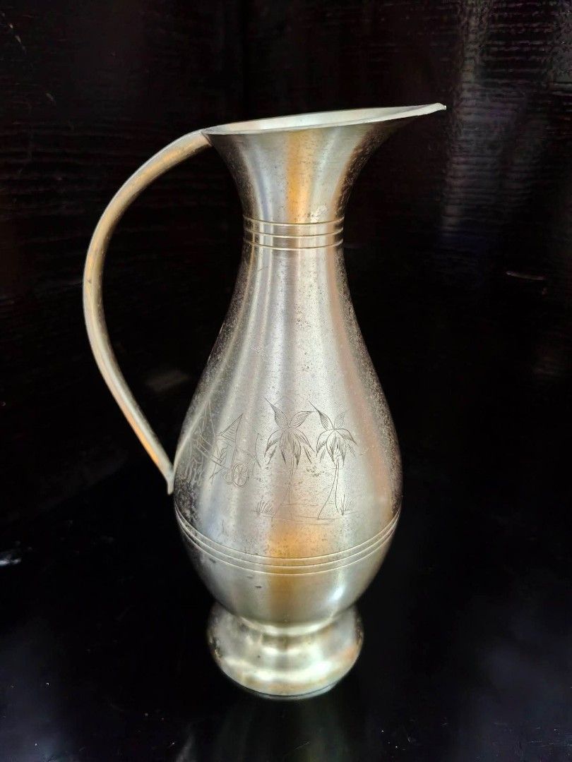 Pewter Pitcher or Vase (Category: Vases & Decorative Bowls) located in Cebu City. Submitted by dudes_villanueva (Listing ID 1461894453, Image 1). Description: Pewter Pitcher or Vase Markings : Pewter Penang Malaysia 📌 Featuring an engraved tropical scene with palm trees. 📌 Has few light scratches and tarnish on some parts. Height : 7.75 in.