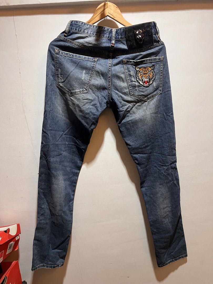 Philipp Plein Jeans Distressed Studded Tiger Patch (Category: Jeans) located in San Juan, La Union. Submitted by jeggystyle (Listing ID 1461965860, Image 3). Description: - Blue denim jeans - Distressed details and metal studs - Unique tiger patch on back pocket - Straight leg fit - Bold and unique design.