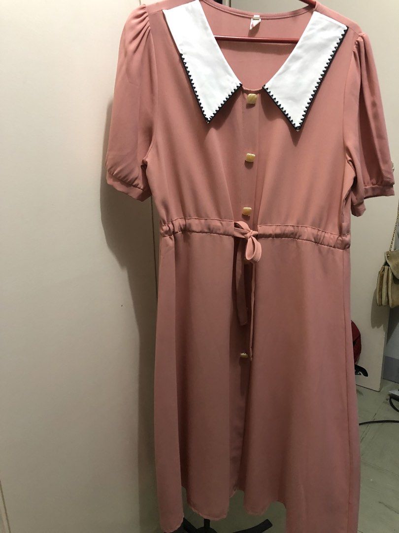 Pink Peter Pan Collar Dress with Buttons (Category: Dresses) located in Tabuk. Submitted by qurst (Listing ID 1461920320, Image 2). Description: - Adorable pink dress - Classic white Peter Pan collar with black trim - Functional buttons down the front - Adjustable drawstring waist for a flattering fit - Sweet short puff sleeves - Ideal for casual outings and picnics.