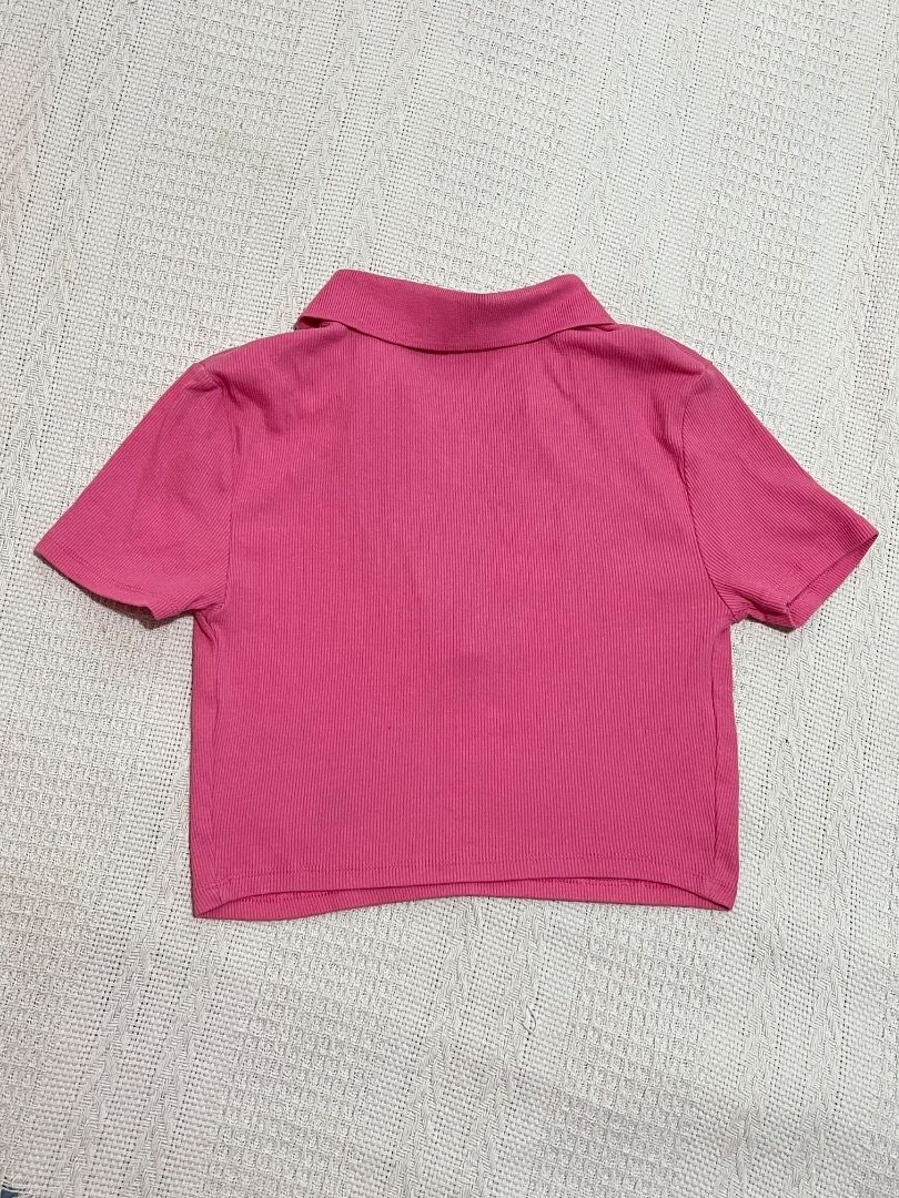 Pink Ribbed Cropped Polo Shirt (Category: Shirts) located in Santa Rosa. Submitted by rsxyen (Listing ID 1461940291, Image 2). Description: - Cute pink cropped polo shirt - Ribbed texture all over - Short sleeves - Collar with V-neck opening - Versatile for casual or dressed-up outfits - Pairs well with high-waisted jeans or skirts.