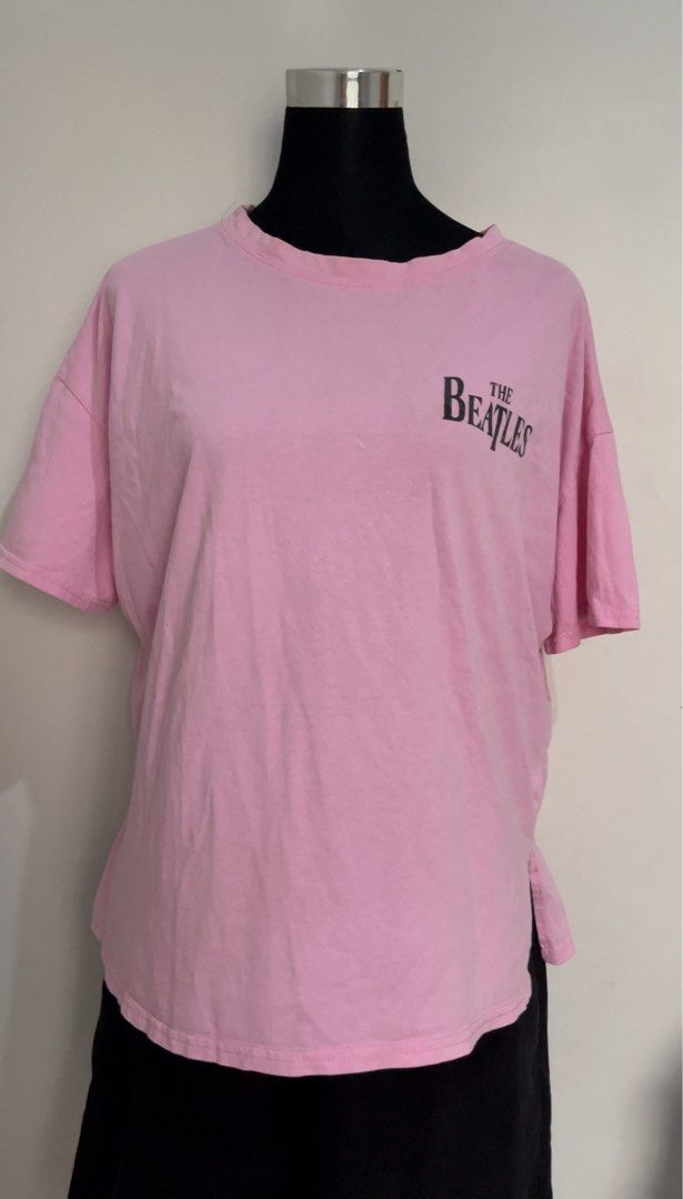 Pink The Beatles T-Shirt (Category: Blouses) located in Santa Rosa. Submitted by totgaaaaa (Listing ID 1461860652, Image 1). Description: - Adorable pink t-shirt featuring a 'The Beatles' graphic. - Comfortable short sleeves and a relaxed fit. - Stylish side slits on the hem. - Ideal for everyday casual wear. - Easily pairs with jeans or shorts. - A must-have for any Beatles fan!.