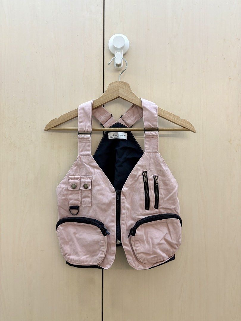 Pink Utility Vest with Multiple Pockets (Category: Others Tops) located in Manila. Submitted by amityclutter (Listing ID 1461922150, Image 1). Description: - Pink utility vest - Ample storage with multiple pockets: - Two zippered pockets on the chest - Two large flap pockets at the bottom - Two buttoned pockets on the left chest - Features a black lining inside - Ideal for layering or as a unique statement piece.