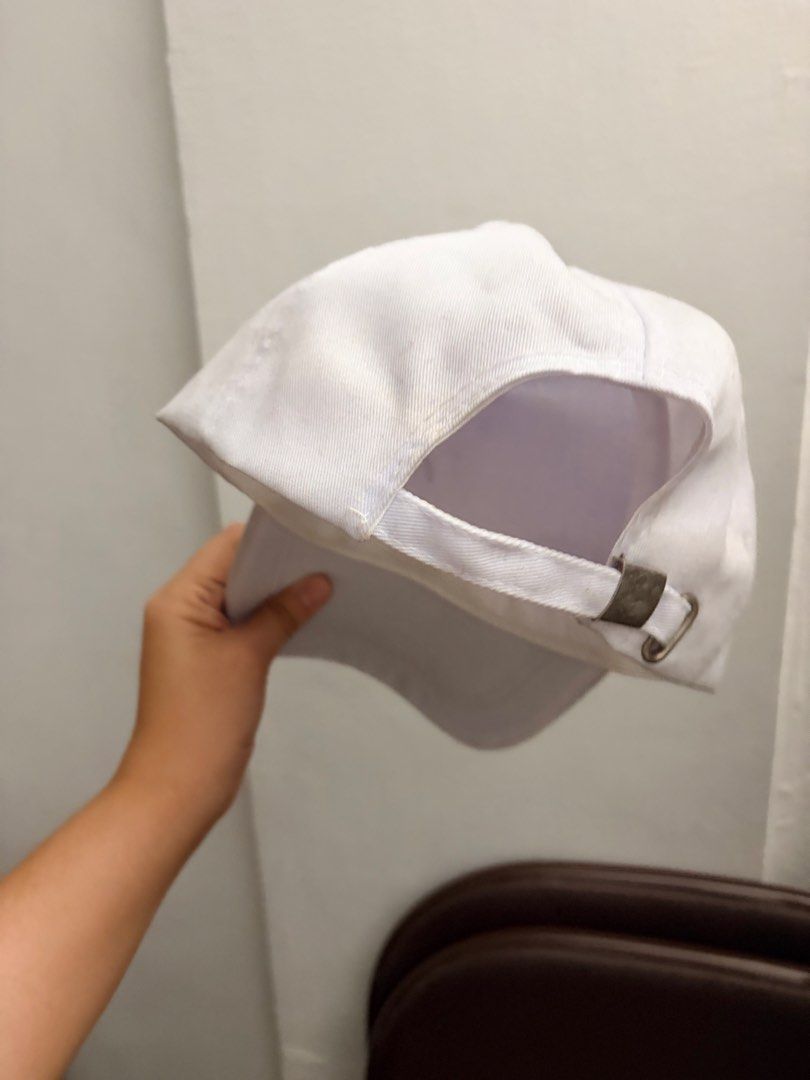Plain White Baseball Cap (Category: Caps & Hats) located in Manila. Submitted by finderskeepersmnl_092026 (Listing ID 1461959840, Image 2). Description: - Classic white baseball cap - Adjustable strap with metal buckle at the back - Perfect for everyday wear or customization projects - Shows minor signs of wear, particularly on the inner band - Cleaned and ready for its new owner.