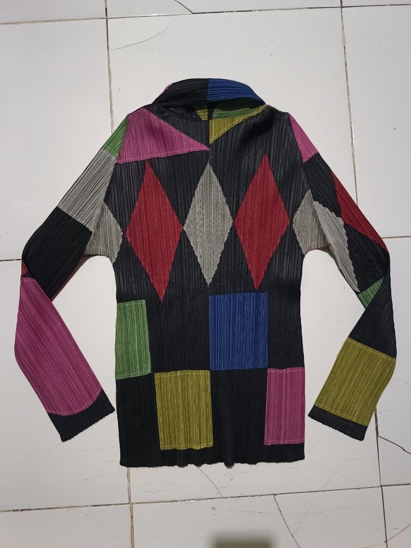 Pleats Please Issey Miyake Patchwork Pleated Long Sleeve Top (Category: Blouses) located in Barotac Nuevo. Submitted by gray101 (Listing ID 1461979721, Image 3). Description: - Unique Pleats Please patchwork design - Features geometric shapes and vibrant colors - Long sleeves with a collared neckline - Zip closure for easy wear - Signature Pleats Please pleats for texture and drape - Made from 100% polyester - A standout statement piece for your 