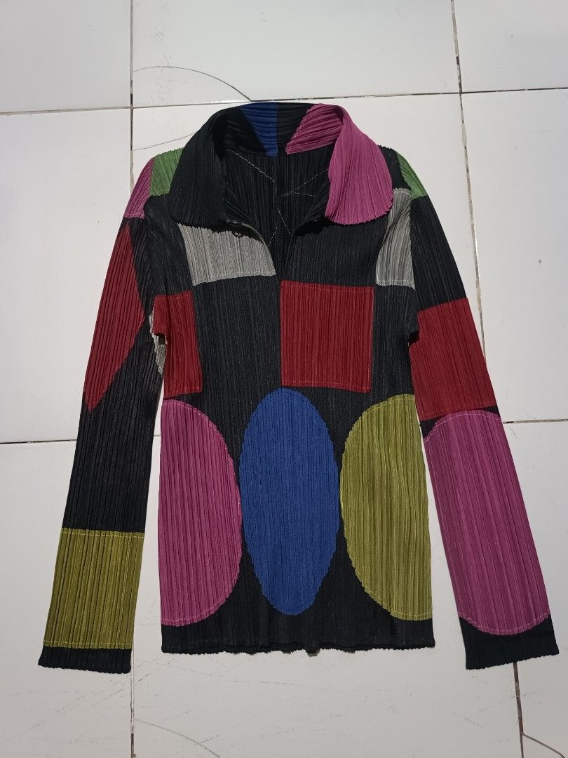 Pleats Please Issey Miyake Patchwork Pleated Long Sleeve Top (Category: Blouses) located in Barotac Nuevo. Submitted by gray101 (Listing ID 1461979721, Image 1). Description: - Unique Pleats Please patchwork design - Features geometric shapes and vibrant colors - Long sleeves with a collared neckline - Zip closure for easy wear - Signature Pleats Please pleats for texture and drape - Made from 100% polyester - A standout statement piece for your 