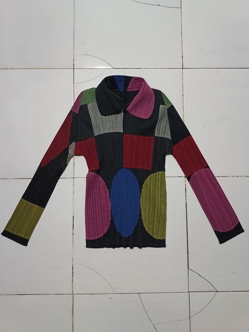 Pleats Please Issey Miyake Patchwork Pleated Long Sleeve Top (Category: Blouses) located in Barotac Nuevo. Submitted by gray101 (Listing ID 1461979721, Image 2). Description: - Unique Pleats Please patchwork design - Features geometric shapes and vibrant colors - Long sleeves with a collared neckline - Zip closure for easy wear - Signature Pleats Please pleats for texture and drape - Made from 100% polyester - A standout statement piece for your 